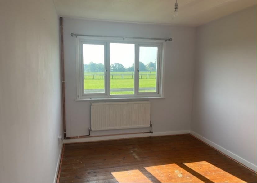Renovated bedroom with a view over green fields