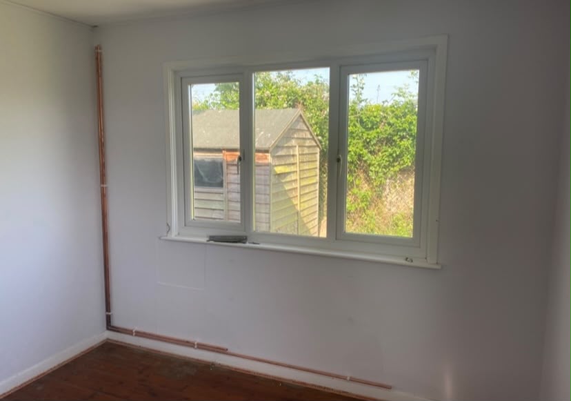 Renovated bedroom overlooking a garden shed