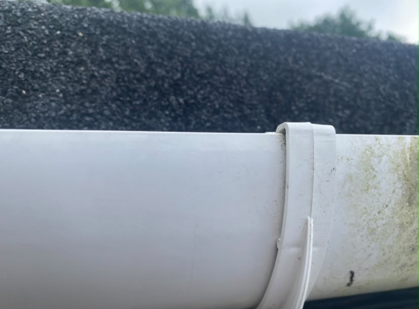 Freshly maintained fascia board on a brick wall