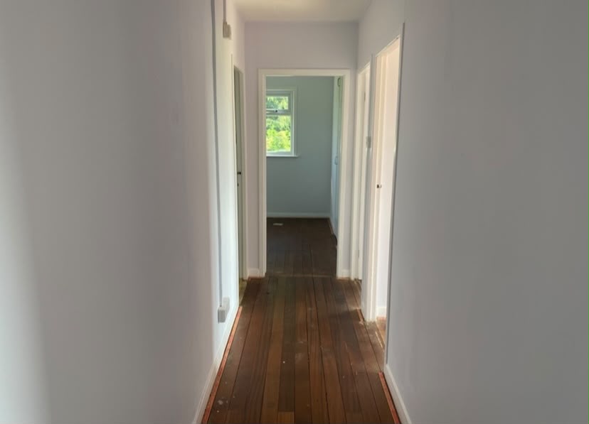 Renovated hallway leading to a bedroom
