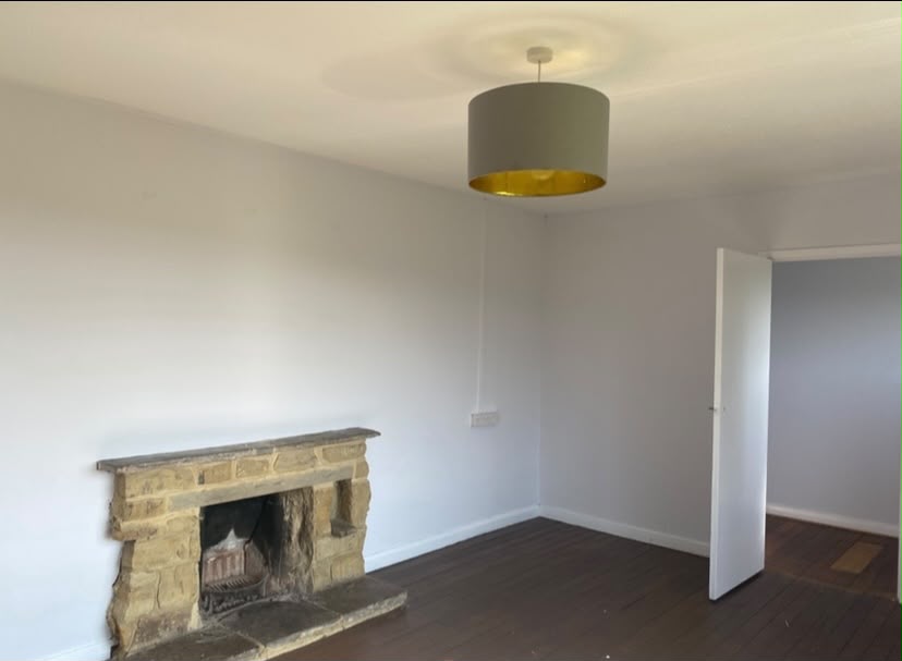 Renovated living room with a stone fireplace