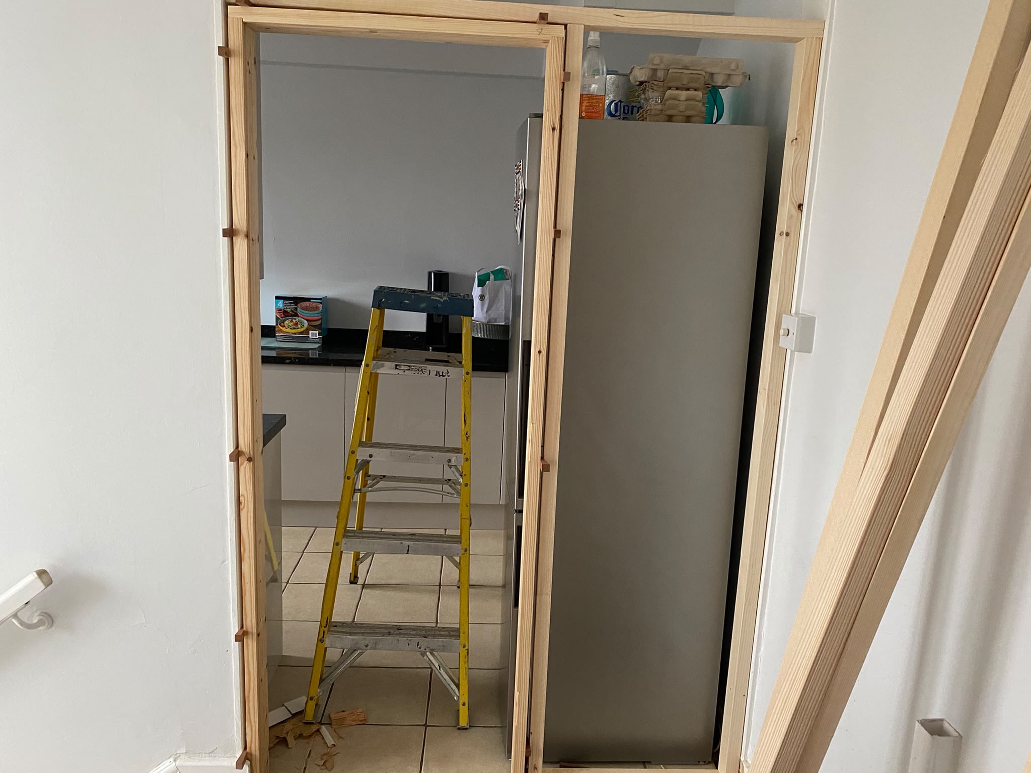 Built-in storage cupboard framed out with door fitted