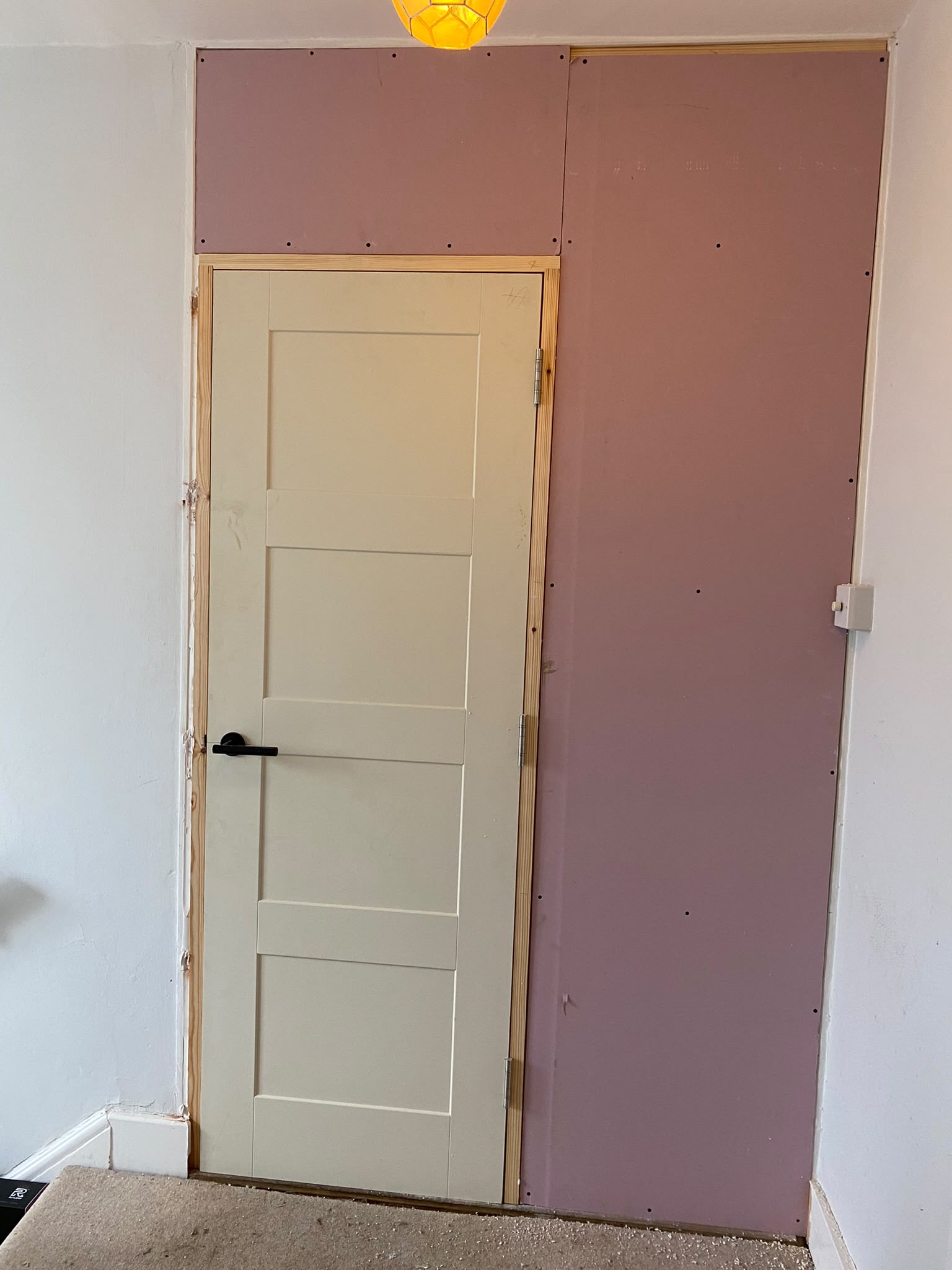 Plasterboard fitted over a built-in storage unit